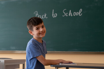 Back to school, boy student smiling in class at school