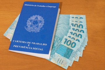 brazilian money banknotes and work card Employment and financial control concept