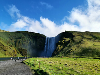 Waterfall iceland tour roadtrip green grass blue sky