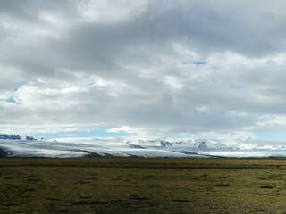 On the way to the J&ouml;kuls&aacute;rl&oacute;n glacier beautifull landscape field grey clouds thunder storm road trip street in iceland