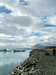 A tourist touristiv viewpoint stop at the J&ouml;kuls&aacute;rl&oacute;n glacier iceberg bridge next to road strett trip with ice in water at iceland island