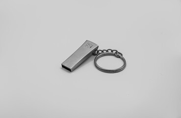 Black and White close-up of a silver 256Gb USB 3.1 portable storage device stick on a key ring chain