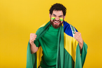 caucasian man with beard, brazilian, soccer fan from brazil, celebrating, yes! wow! Victory.