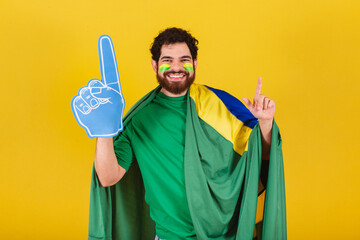 man, brazilian, bearded, soccer fan from brazil, using foam finger doing dance choreography for...