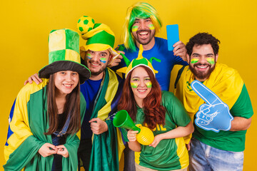 group of friends, soccer fans from Brazil, cheering and getting ready to follow a soccer match.