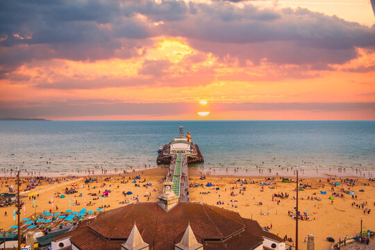 sunset over the sea at Bournemouth illuminating the clouds and the sea 