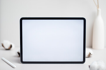 Tablet empty white screen with pencil and cotton flower on white background mockup for design