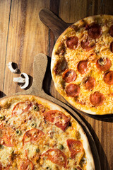 Three pizzas of different flavors. Pepperoni, cheese, potato, onion, tomato. Italian pizza.