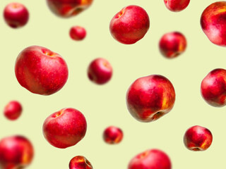 Flying levitating floating red ripe fresh juicy apples in air on beige background. Levity summer fruits. Trendy, minimal,creative food.healthy nutrition