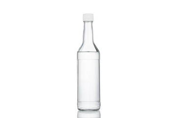 Glass transparent bottle with a white cap on a white background.