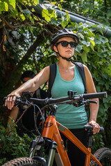 One woman caucasian female ride electric bicycle e-bike in summer day