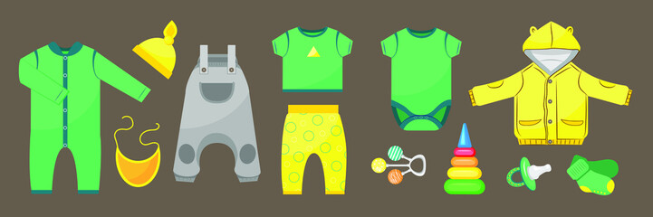 Set of baby clothes and accessories on dark background