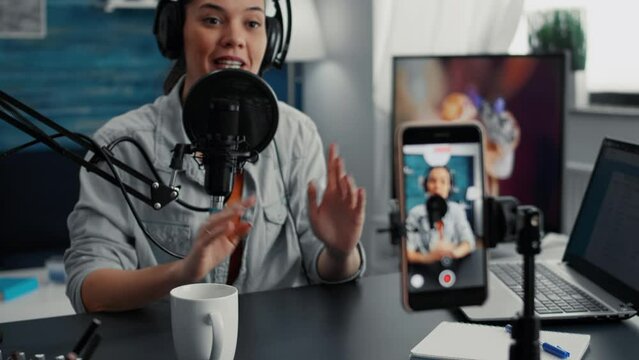 Friendly internet live show host talking to audience while presenting last worlwide news and events. Creative digital content creator recording daily video blog while talking with public.