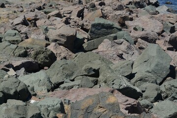 Rocky beach on sunny day as background
