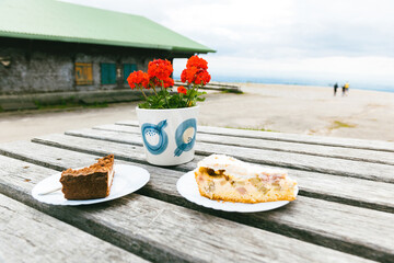 Delicious german pastries kuchen with gardenia flower as seen on the table - tallest peak in German Black Forest