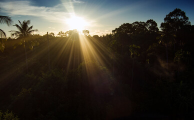 Fototapeta Sunrise over ko samui island from  a drone capture with jungle and land mass in the frame - strong sun rays - Maenam village in Thailand obraz