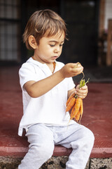 Toddler with organic carrots