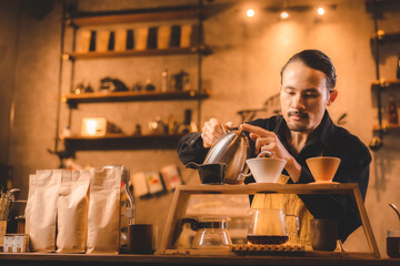 hipster barista pouring a hot water to making coffee with drip or filter style in cafe, slow brew for caffeine aroma beverage drink in cup, fresh black coffee and espresso for breakfast