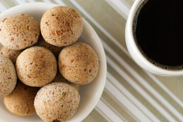 top view of cheese bread with black coffee - pao de queijo tradicional com cafe preto (brazilian food)
