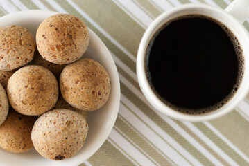 top view of cheese bread with black coffee - pao de queijo tradicional com cafe preto (brazilian food)