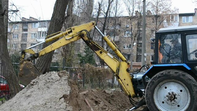 yellow excavator bucket aka scoop grab the ground, rescue technology, agrimotor aka tractor arm cover the firetrench, industry diversity