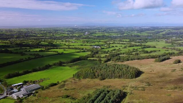 Drone View Of Sunny Autumn Evening English Country Scene With Woods In Lancashire Looking Towards Heysham Nuclear Power Station