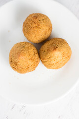 top view of 3 coxinhas in a white plate - brazilian food, chicken croquette