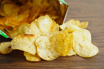 Potato chips in open bag, delicious BBQ seasoning spicy for crips, thin slice deep fried snack fast food in open bag.