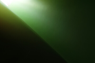 Coated green paper with the gradient in the corner, background texture