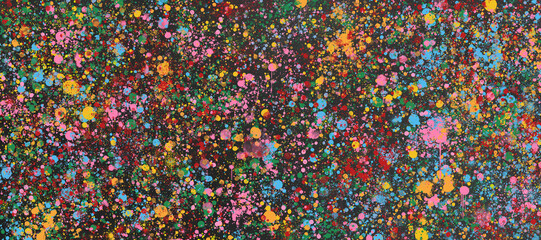 Colorful grunge paint image with spray splashes on black background