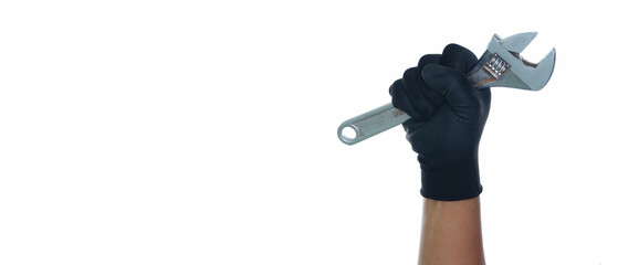 Hand wearing black gloves holding adjustable wrench isolated white background with copy space
