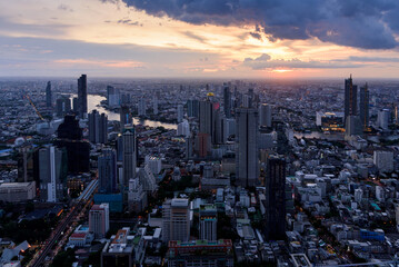 View of downtown Bangkok at sunset with Chao Praya  river in the background , city skyline