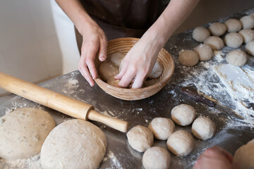 The process of making traditional French bread in a craft bakery. Molding of the Bordeaux crown....