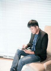 Fototapeta premium Young businessmen, entrepreneurs use iPad technology to help manage and control equipment in factories.