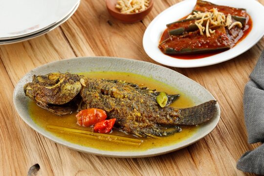 Spicy Gourami Fish Stew in Yellow Curry Spice. Thai and Indonesia Style