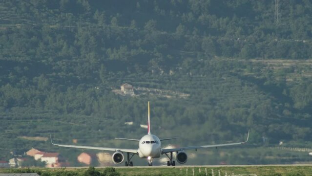 A passenger plane is traveling on the runway. Airport take offs and landings tourism. High quality 4k footage