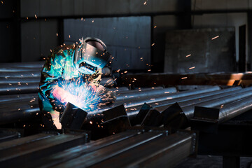 Industrial welder welding metal profiles - Powered by Adobe