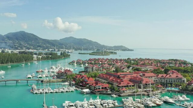 Aerial view Victoria Seychelles. Yacht parking near a luxury resort on an island in the Indian Ocean. Beautiful landscape of mountains with beaches near the ocean. High quality 4k footage