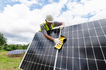 Engineer cleaning solar panels Hand wipe the solar panel from dirt.Cleaning mini photovoltaics...