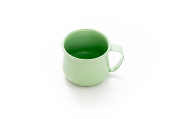 Green mug isolated on white background. Kitchenwear. Tablewear. Product design. Minimalist object. Simplicity. Daily use. Household.
