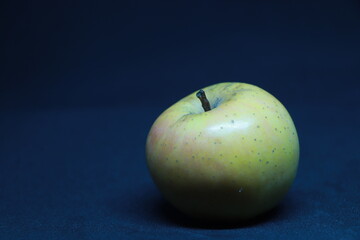 Fresh yellow apple isolated on blue background
