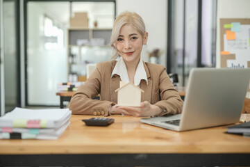 Asian businesswoman using calculator and financial documents at the table office, business financial concept.