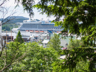 Cruise-ship berthed and viewed through green foliage at Ketchikan