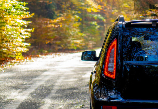 Car Traveling In Fall Forest