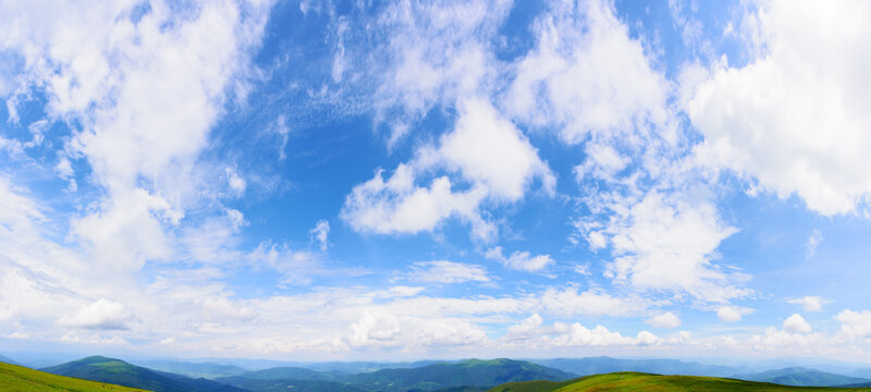 panorama of a blue sky with fluffy cumulus clouds. bright sunny weather forecast in summer. beautiful scenery with horizon above the distant ridge