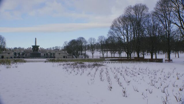 The Vigeland exhibition at Frogner park on a sunny with clouds, snowy winter day