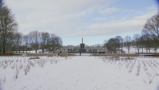 The Vigeland exhibition at Frogner park 2, wide shot of sculptures on a sunny with clouds, snowy winter day