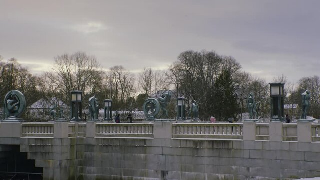 The Vigeland exhibition at Frogner park, wide bridge shot on a sunny with clouds, snowy winter day