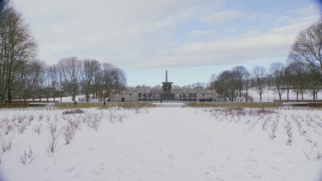The Vigeland exhibition at Frogner park, wide shot of sculptures on a sunny with clouds, snowy winter day