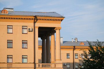 Big beautiful building with long columns and many windows in the city